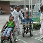 Children playing together, some in wheelchairs, some not