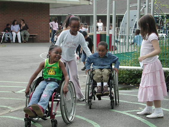 Children playing together, some in wheelchairs, some not
