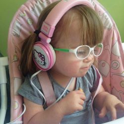 Ava wearing pink headphones