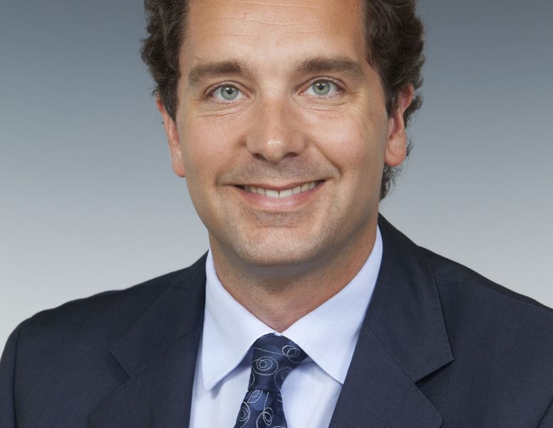 Edward Timpson, smiling at the camera, wearing a suit