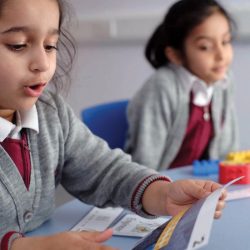 Two small girls in school unifocm in class