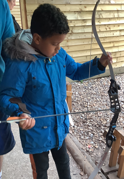 Pyrcroft School visit: Action shot of a pupil doing archery