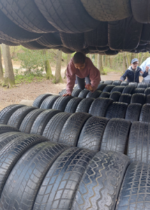 Pyrcroft School visit, action shot of a pupil climbing on tyres