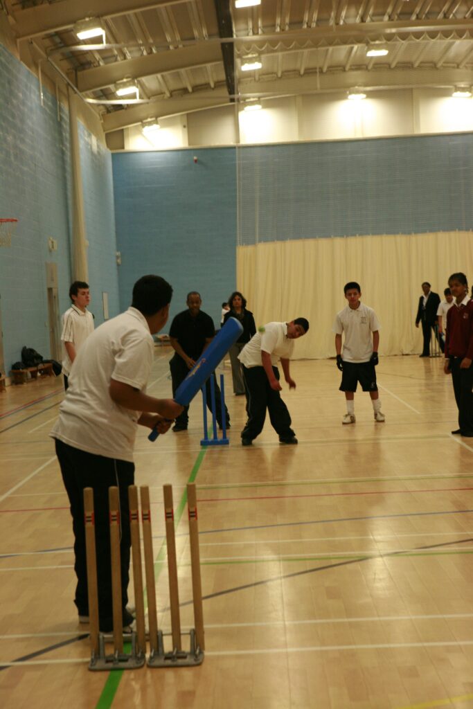 Young people attending Monega Primary School in Newham, London. Wide angle shot showing colllaborative and group activities: Cricket for All, Langdon