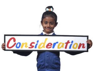 Monega Primary School 2, pupil holding a sign with the text 'Consideration'. Copyright: Monega Primary School